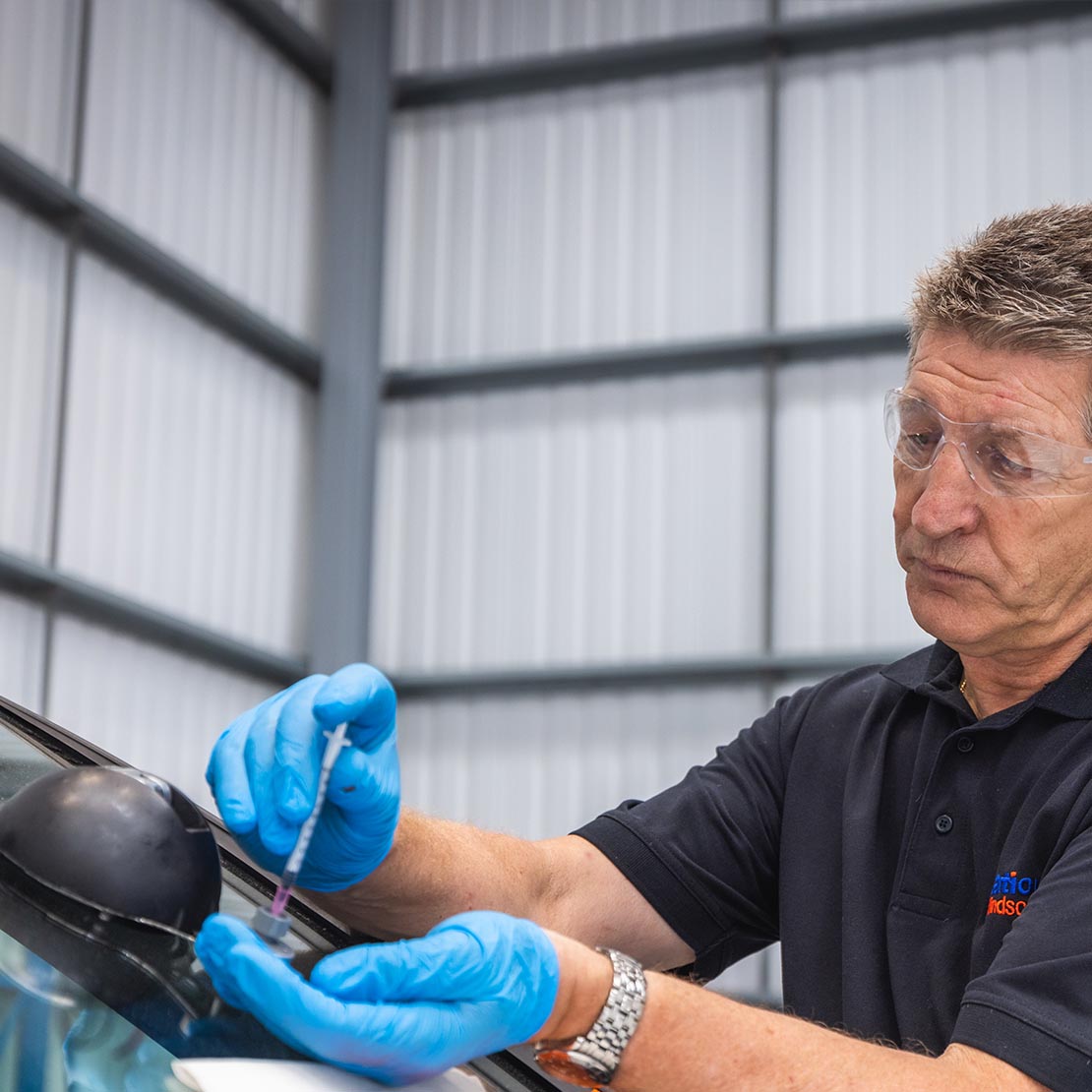 Windscreen technician repairing windscreen